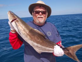 Gene with a 22-pound cobia that finally took a live blue runner after circling the boat for 30 minutes off Jupiter. 