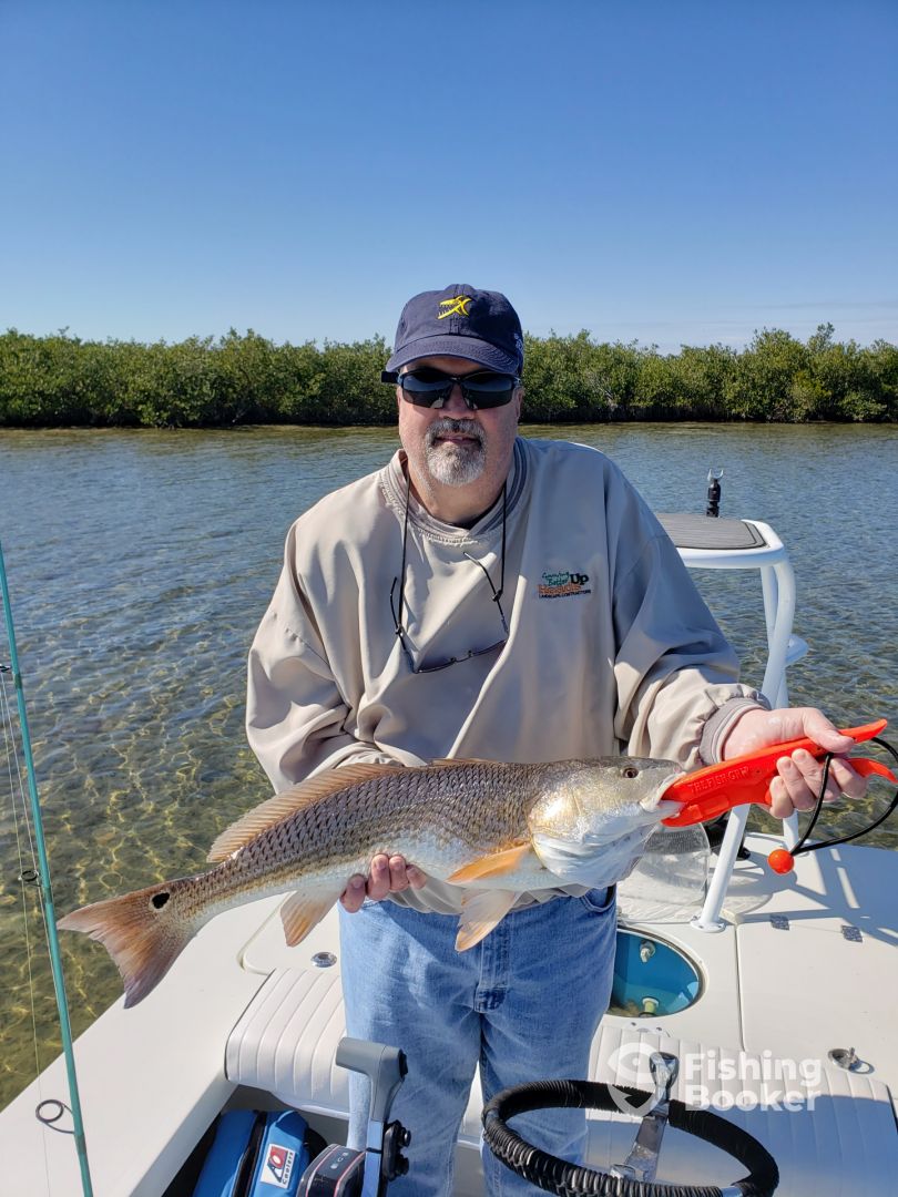 client with redfish in mosquito lagoon