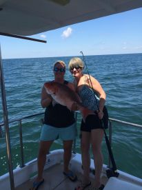 Carla shows off o e of many snapper she reeled to the boat!
