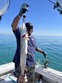 Four guys and a captain on the boat
